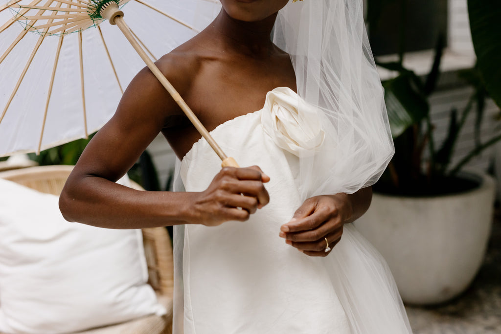 Bride holds personalised parasol umbrella at wedding ceremony