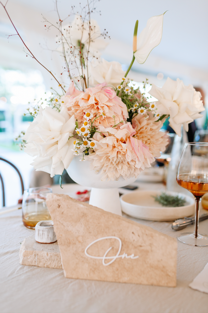 Travertine table number and wedding florals