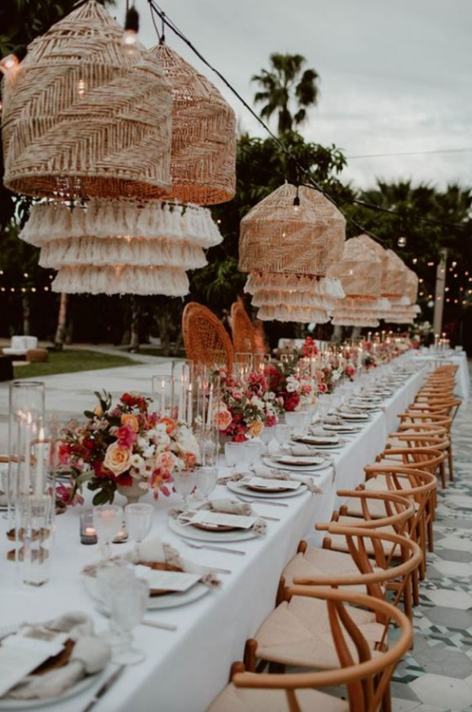 Modern Bohemian wedding decor with hanging rattan chandeliers