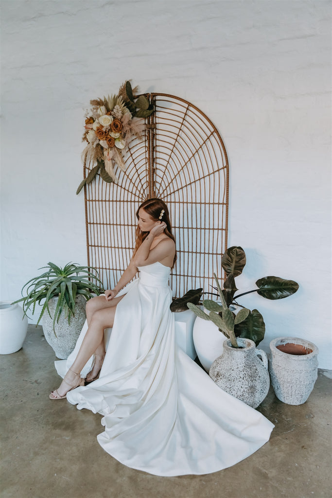 Bride sits in front of wedding ceremony hire package