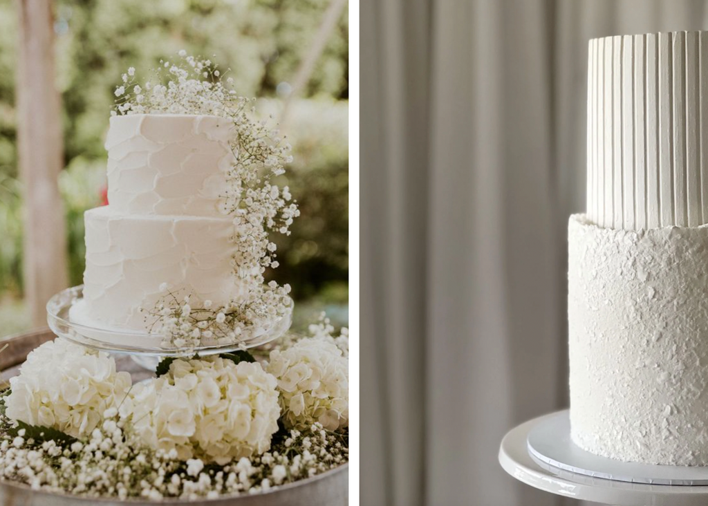 Image 1: Two tier, white wedding cake with organic textures and ordained with white roses and baby's breath. Image 2: Two tier white wedding cake with organic textures