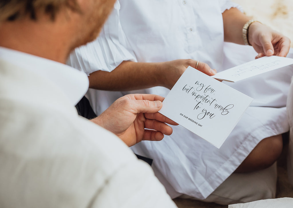 Groom reads card on his wedding day
