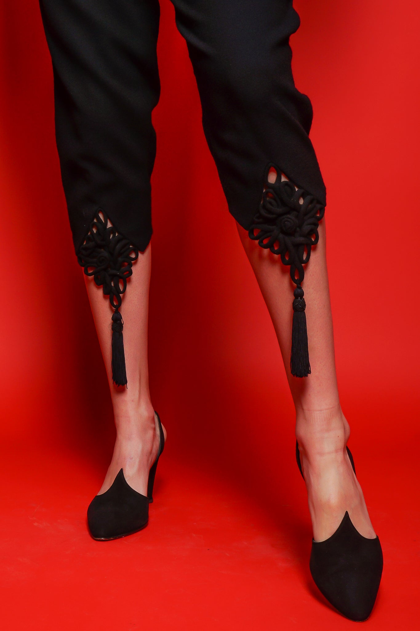 black M.Yoko frog tassel pant and vintage heel on red background at Recess Los Angeles