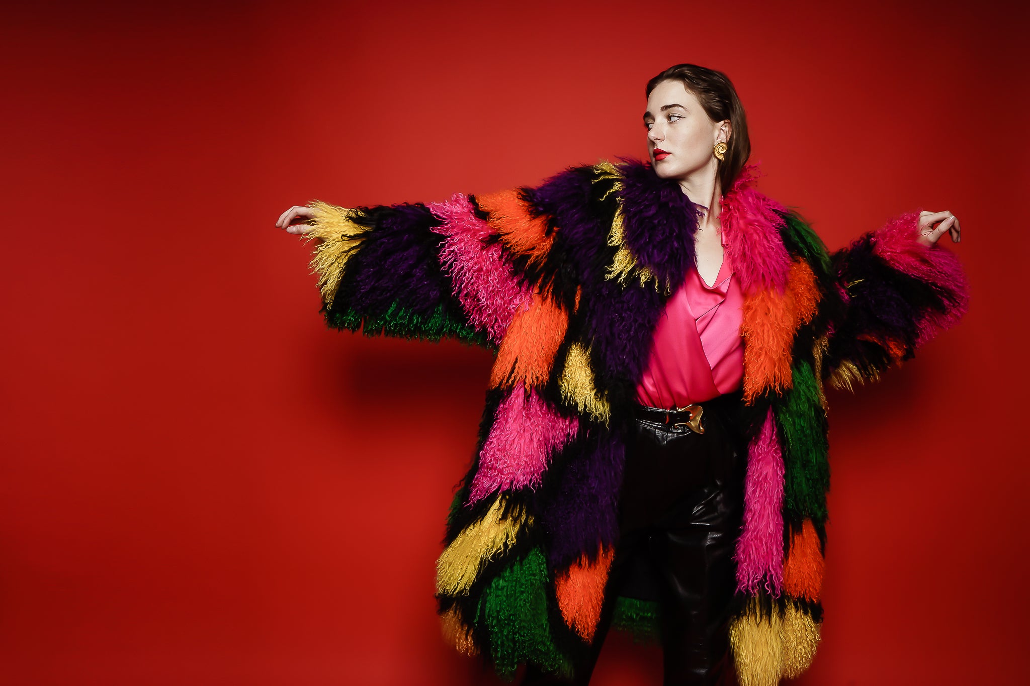 Girl in Neiman Marcus rainbow Mongolian fur & YSL leather pant on red at Recess Los Angeles