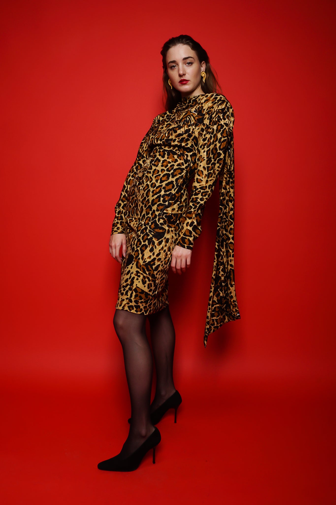 Girl in YSL Yves Saint Laurent Leopard Scarf Dress on red background at Recess Los Angeles