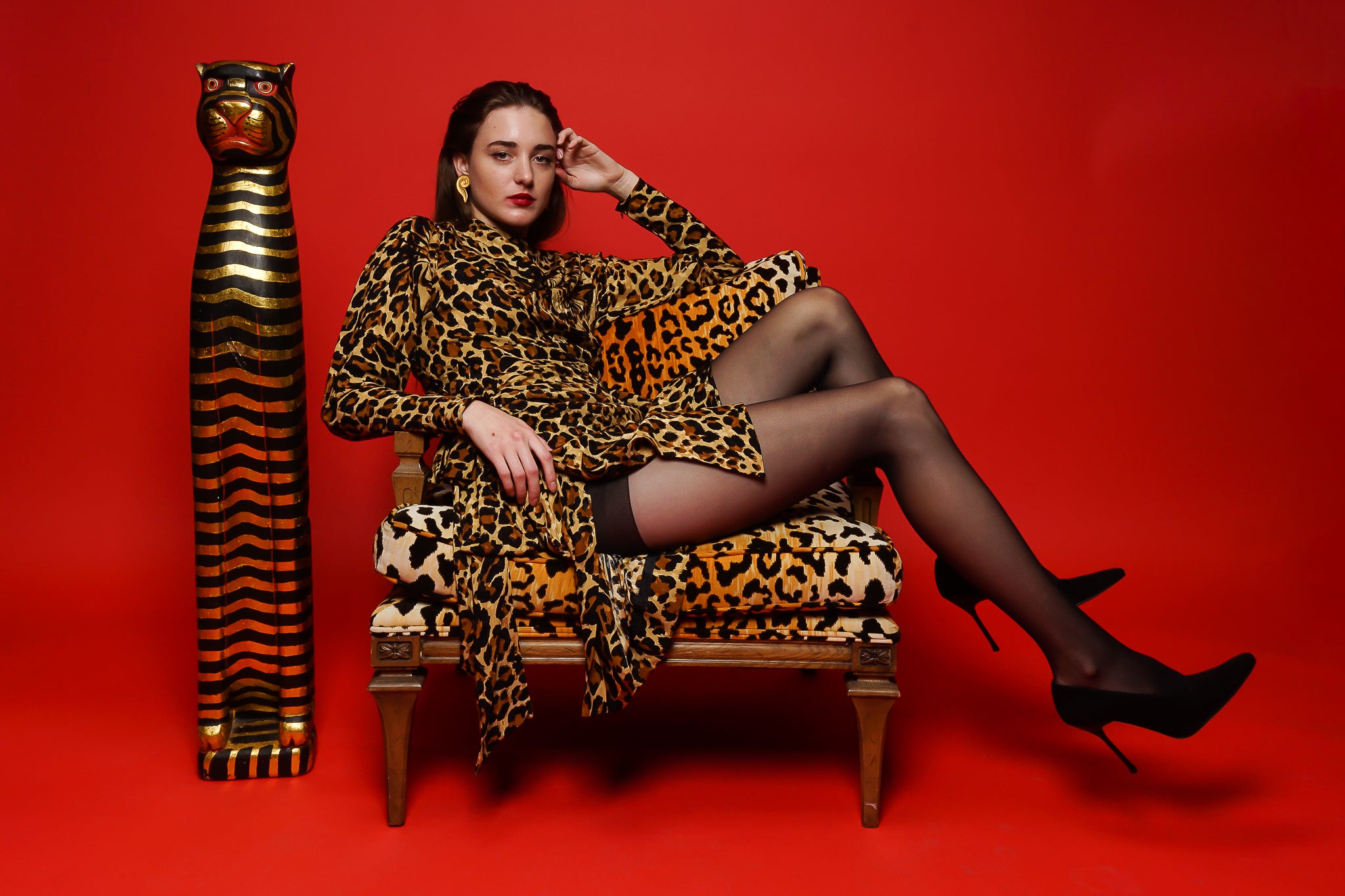 Girl in YSL Yves Saint Laurent Leopard Scarf Dress in animal chain on red at Recess Los Angeles