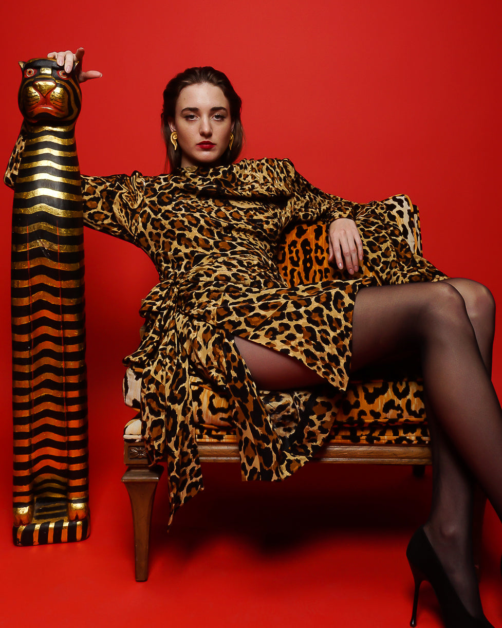 Girl in YSL Yves Saint Laurent Leopard Scarf Dress in animal chair on red at Recess Los Angeles