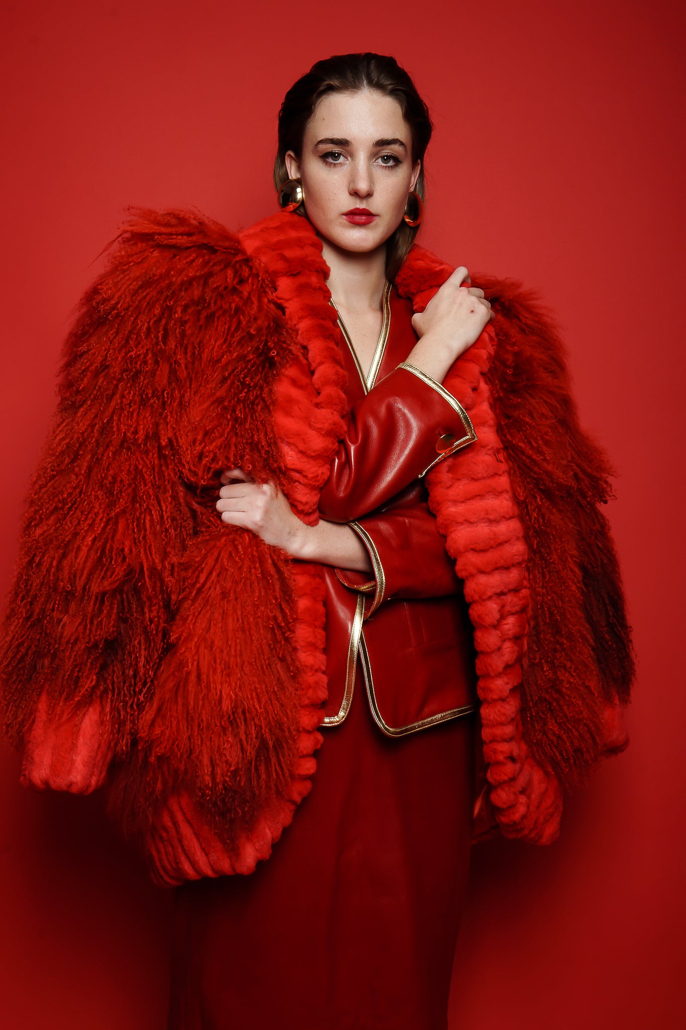 Girl in red vintage Yves Saint Laurent leather suit and Mongolian fur on red at Recess Los Angeles