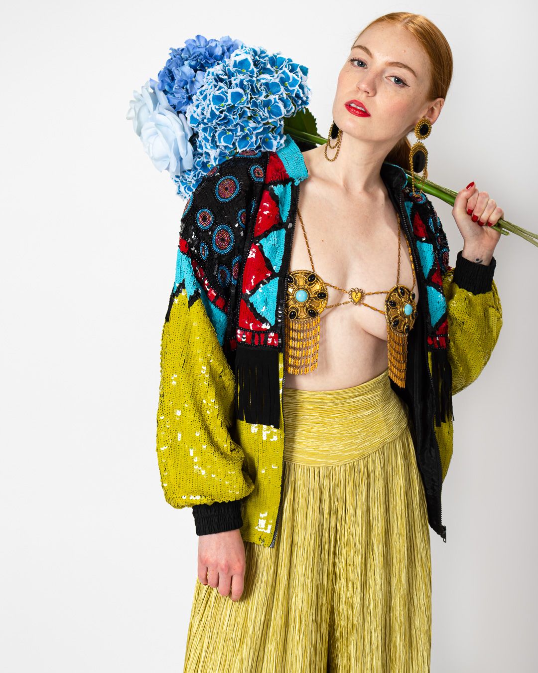 Emily O'Dette in Mary Mcfadden Couture Palazzo Pants, Modi Sequin Jacket, Filigree Medallion Harness