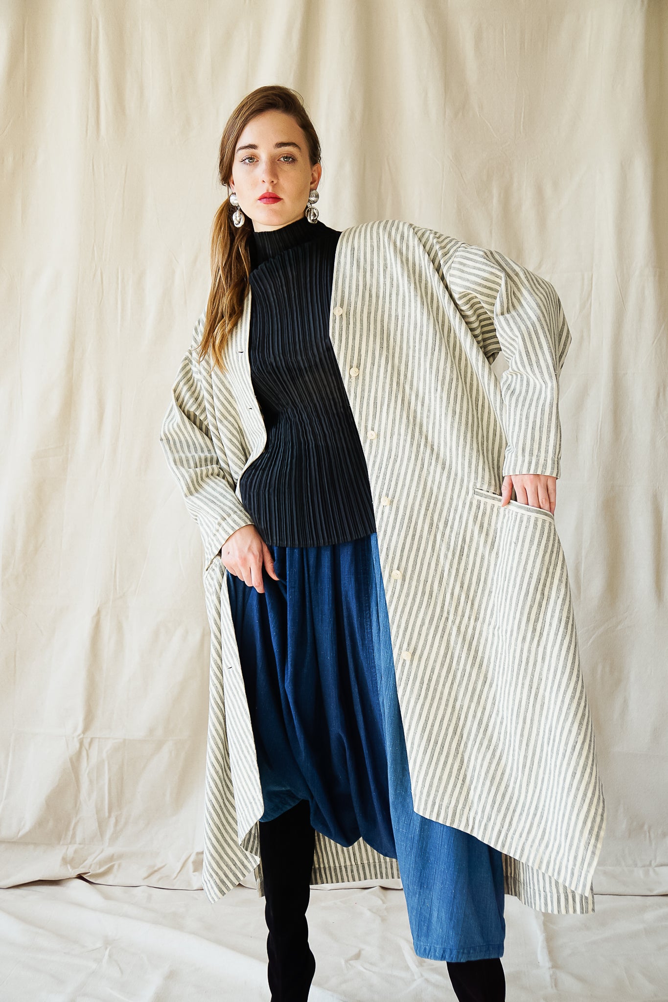Recess Vintage Consignment LA Girl in black Issey Miyake top & stripe coat w/ Plantation harem pant