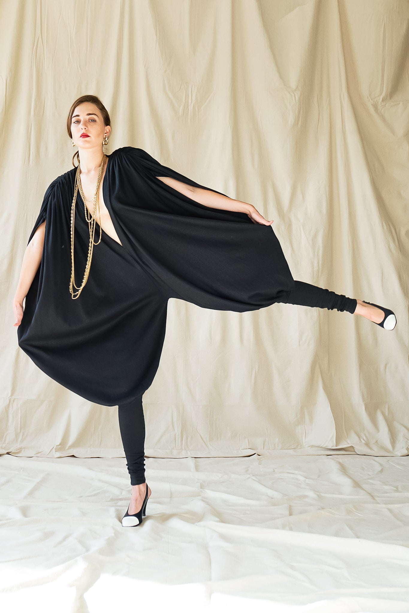 Recess Vintage Consignment Girl wearing black Norma Kamali iconic 80s bubble jersey knit jumpsuit