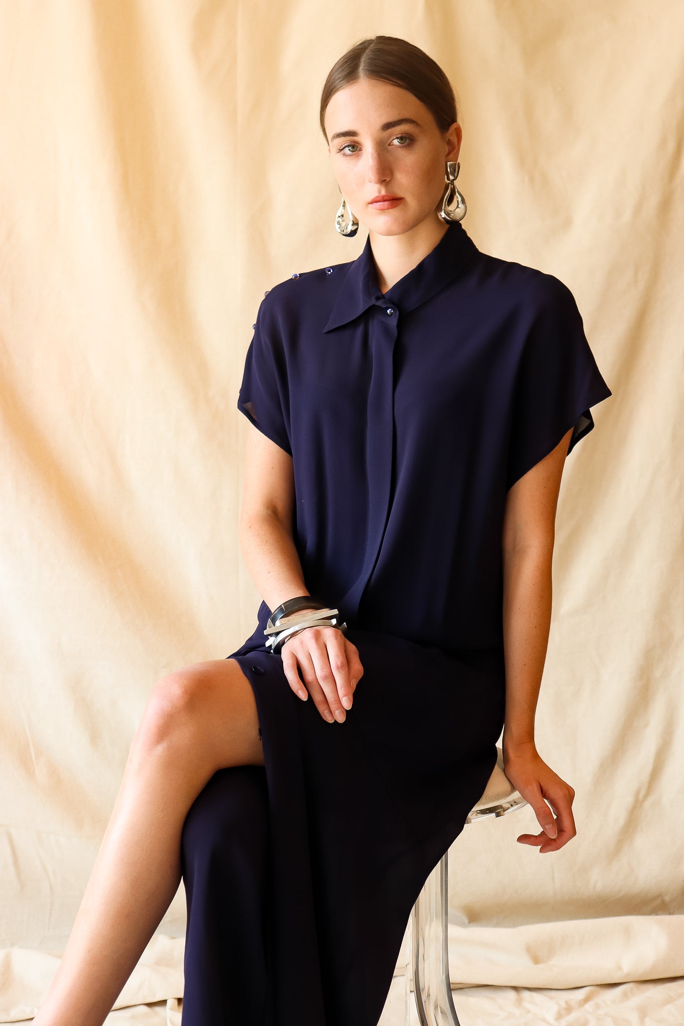 Recess Vintage Consignment LA Girl sitting in sheer navy Karl Lagerfeld Dress
