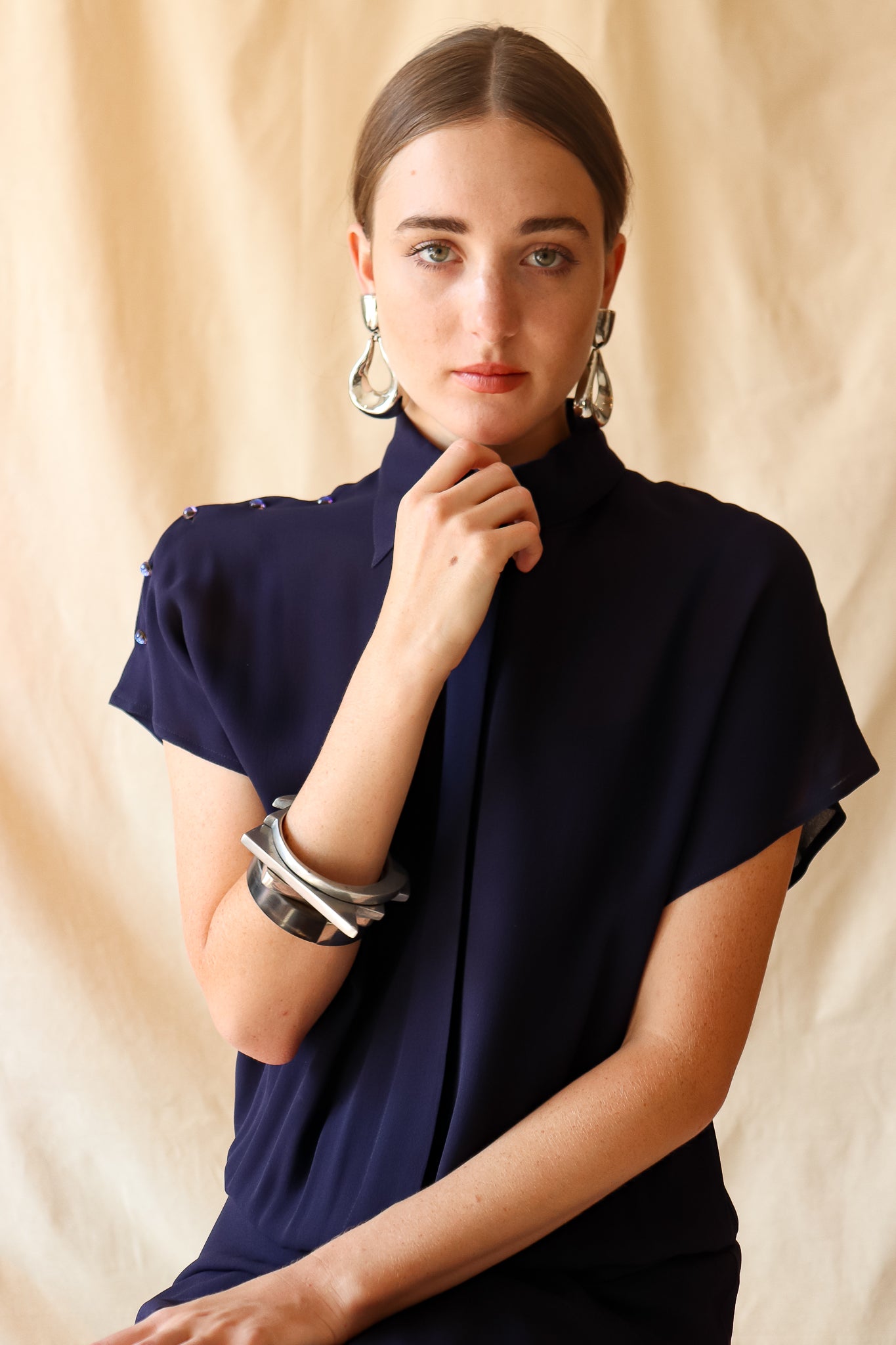 Recess Vintage Consignment LA Girl in sheer navy Karl Lagerfeld Dress with bracelets