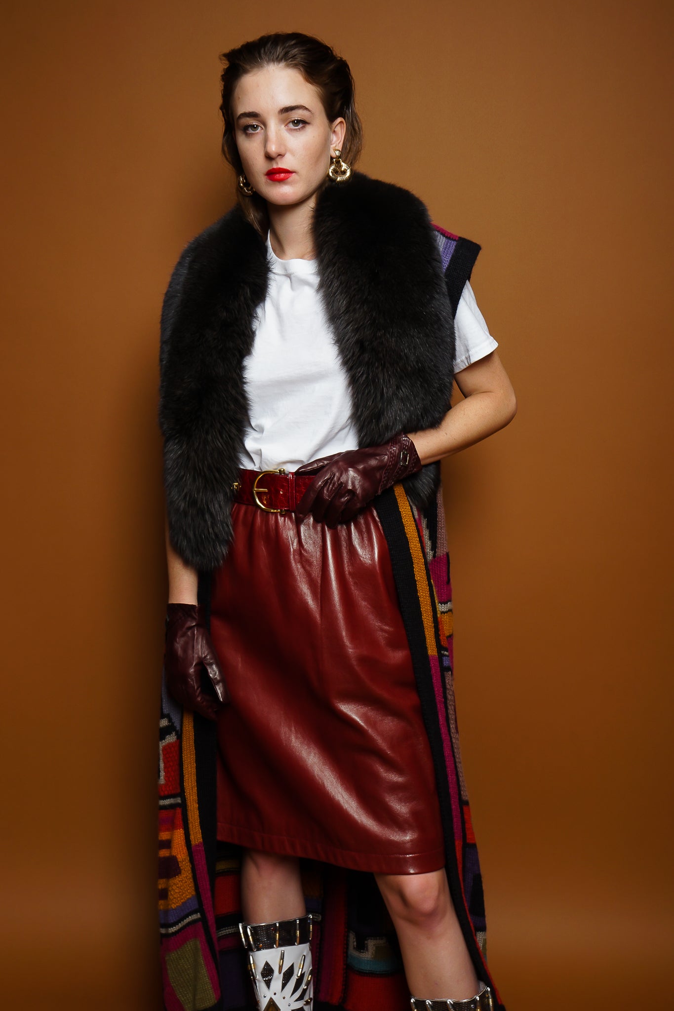 girl in Long Peruvian Connection duster vest & YSL leather skirt on brown @ Recess Los Angeles