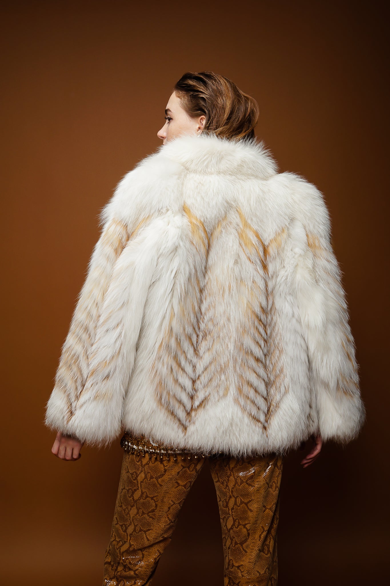 girl in Saga Fox fur jacket, Valentina sequin vest, Braude snake pant on brown @ Recess Los Angeles
