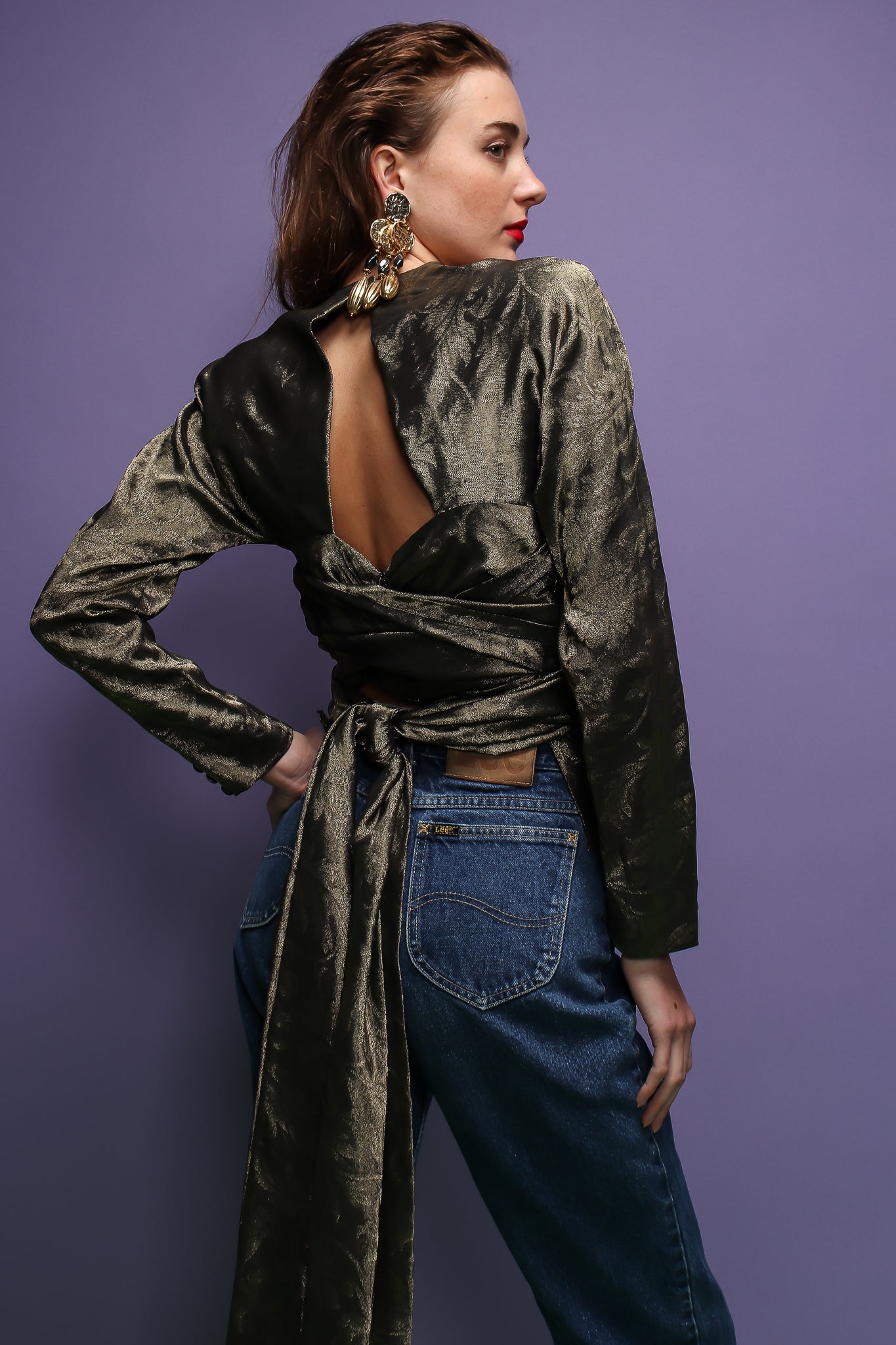 girl in sage silk Carolyne Roehm tie back top & jeans on purple at Recess Los Angeles
