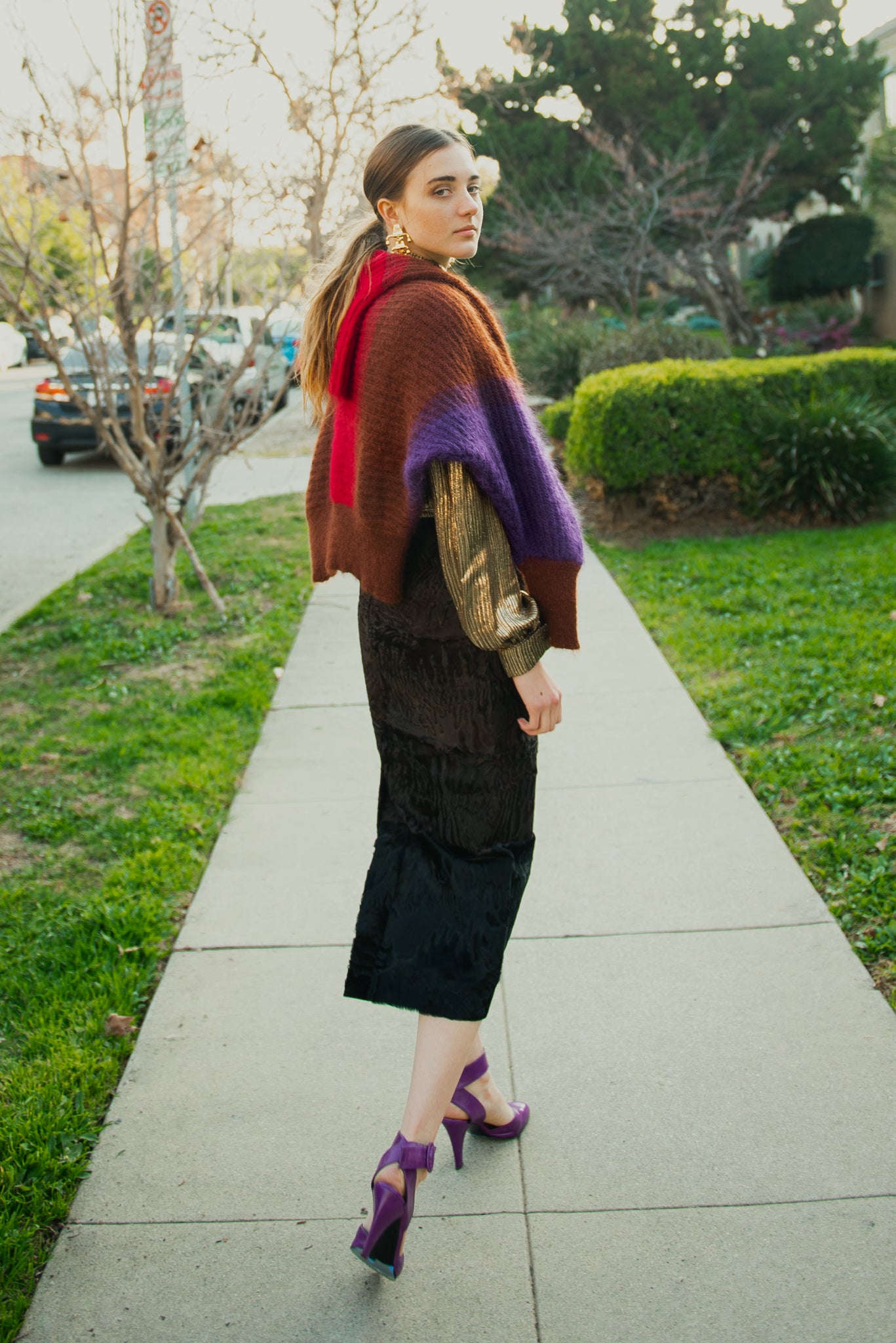 Girl in gold Jacques Molko blouse and Fendi Persian Lamb Skirt on sidewalk