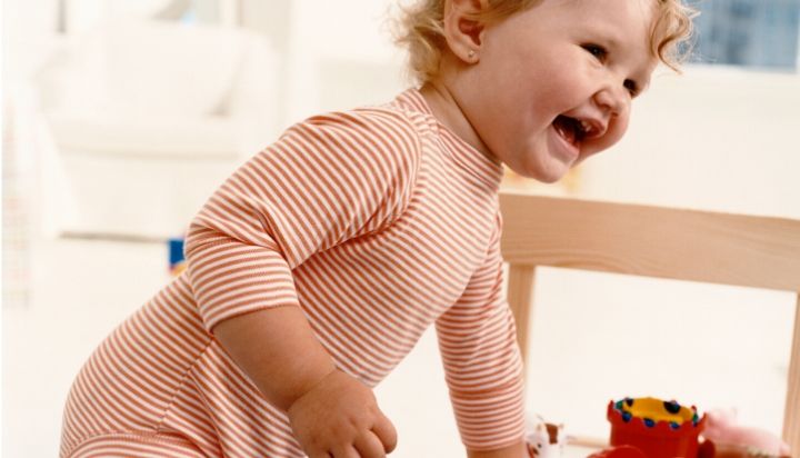 toddler smiling in onesie