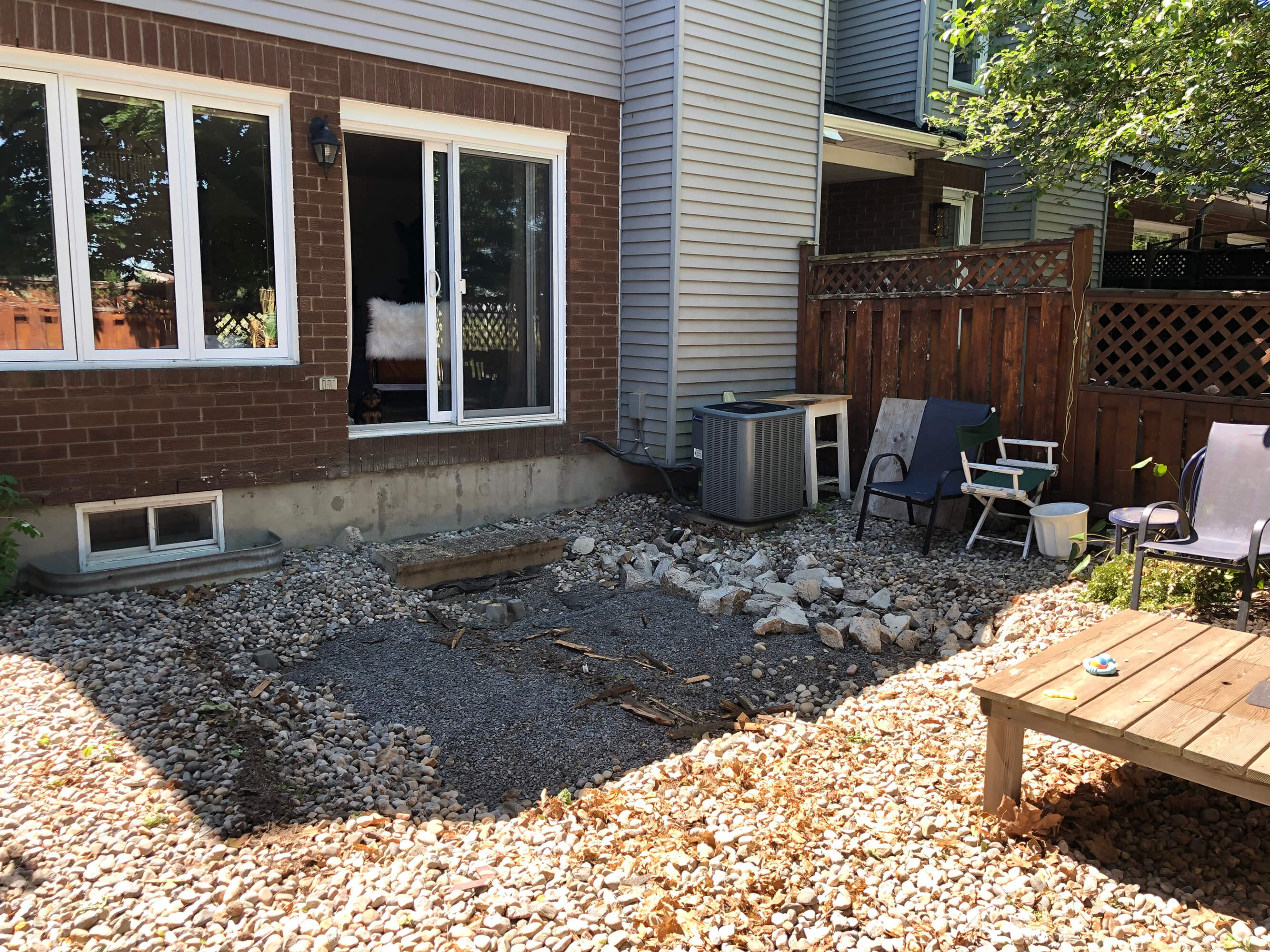 Ottawa interior design studio, West of Main's backyard transformation with old deck removed before work began.