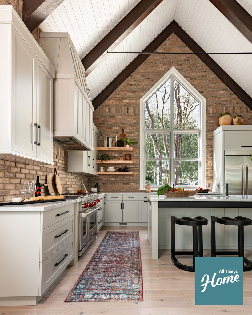 luxury lake home kitchen with brick backsplash. 