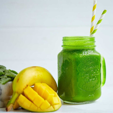 Tropical Paradise Smoothie shown in glass jar with banana, mango and spinach