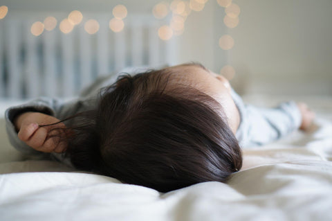 Baby napping in a crib