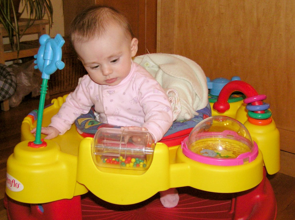 baby playing in an activity center