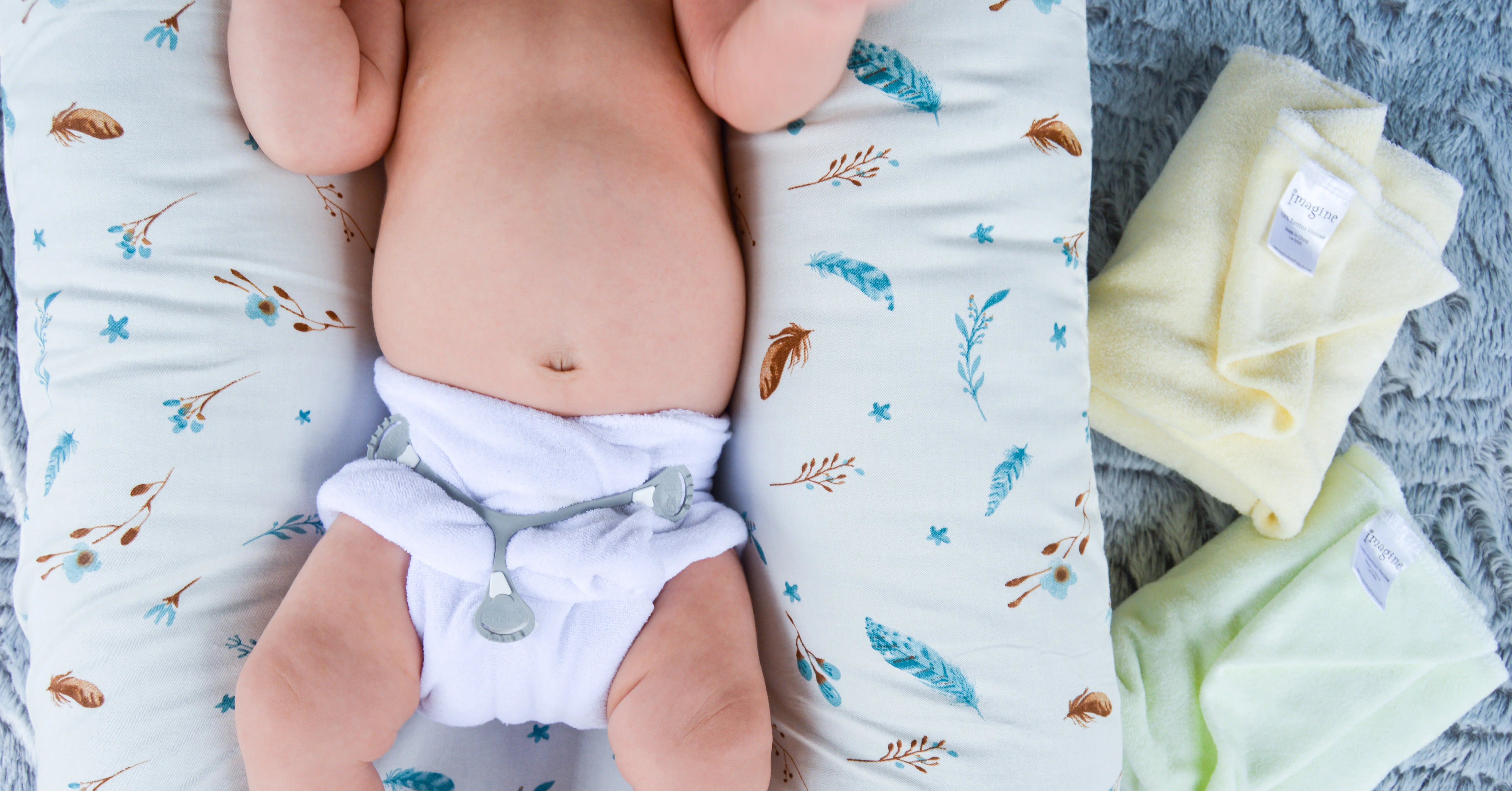 Baby laying down in cloth diaper