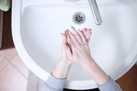 washing hands in sink