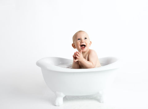 Baby smiling in bathtub 