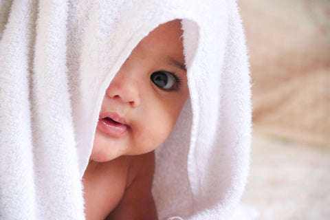 Baby with towel on its head 