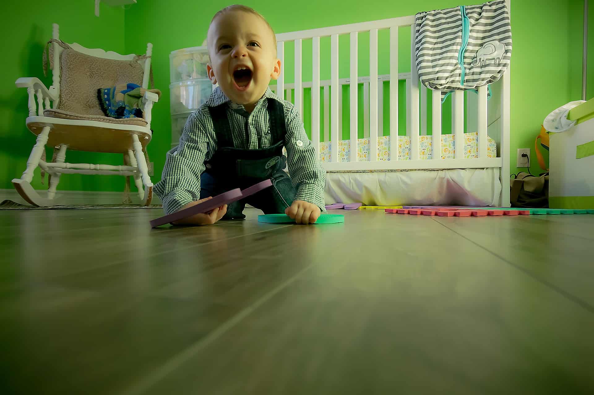 Baby playing on the floor of a nursery