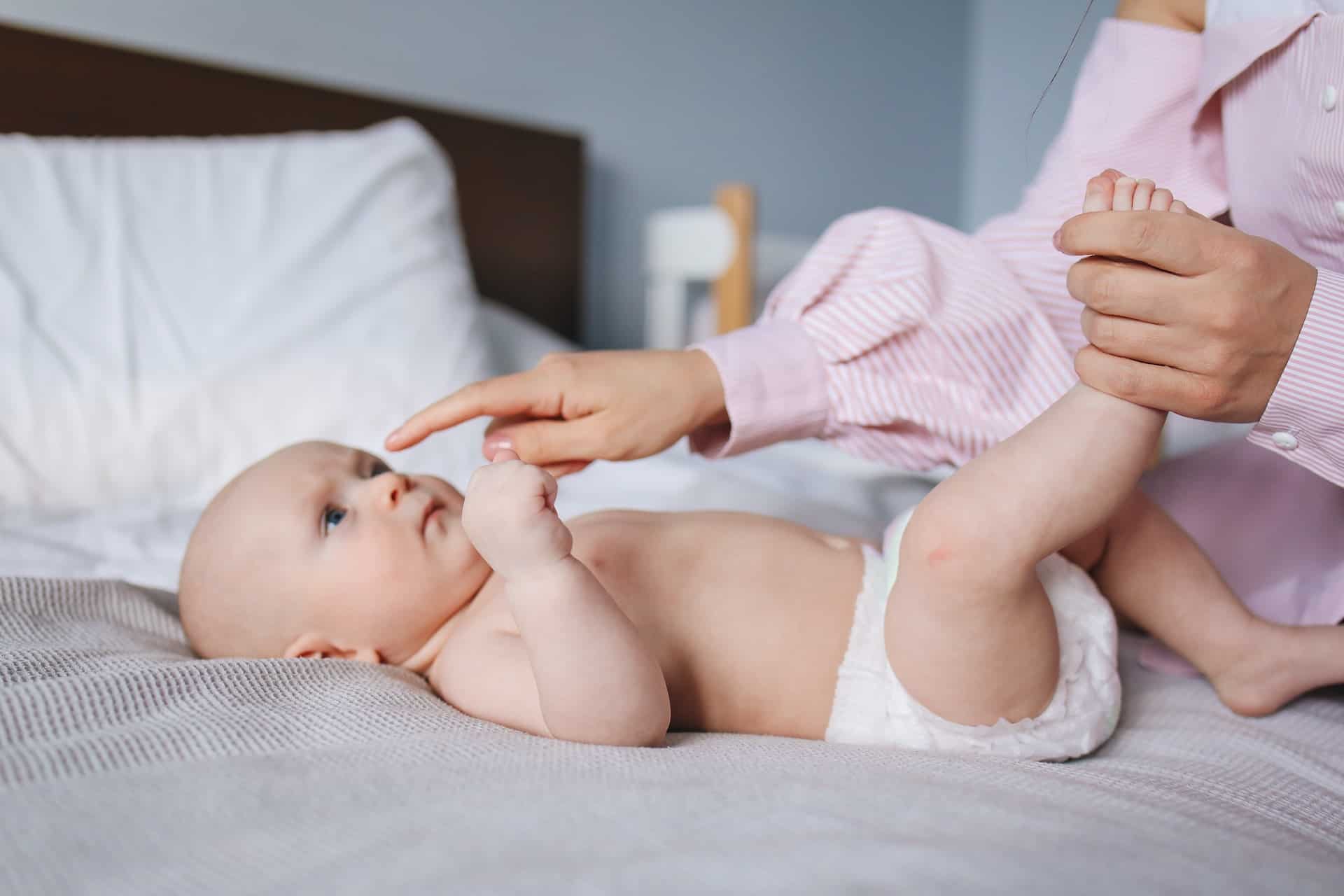 Mother Playing With Baby on Bed