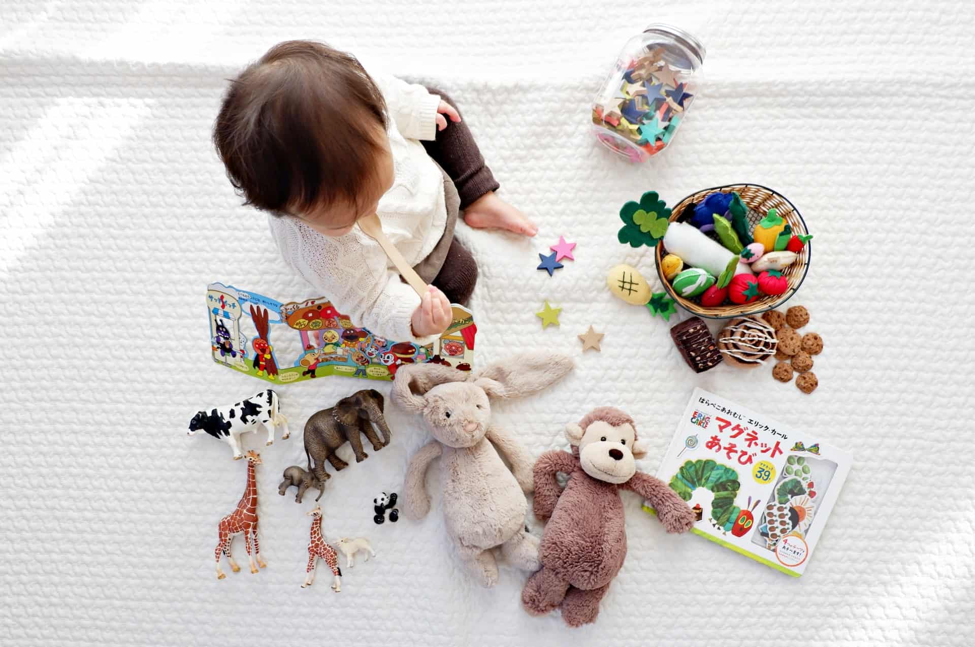 baby surrounded by toys