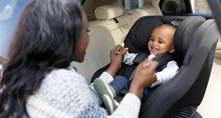 a smiling baby in a rotating car seat