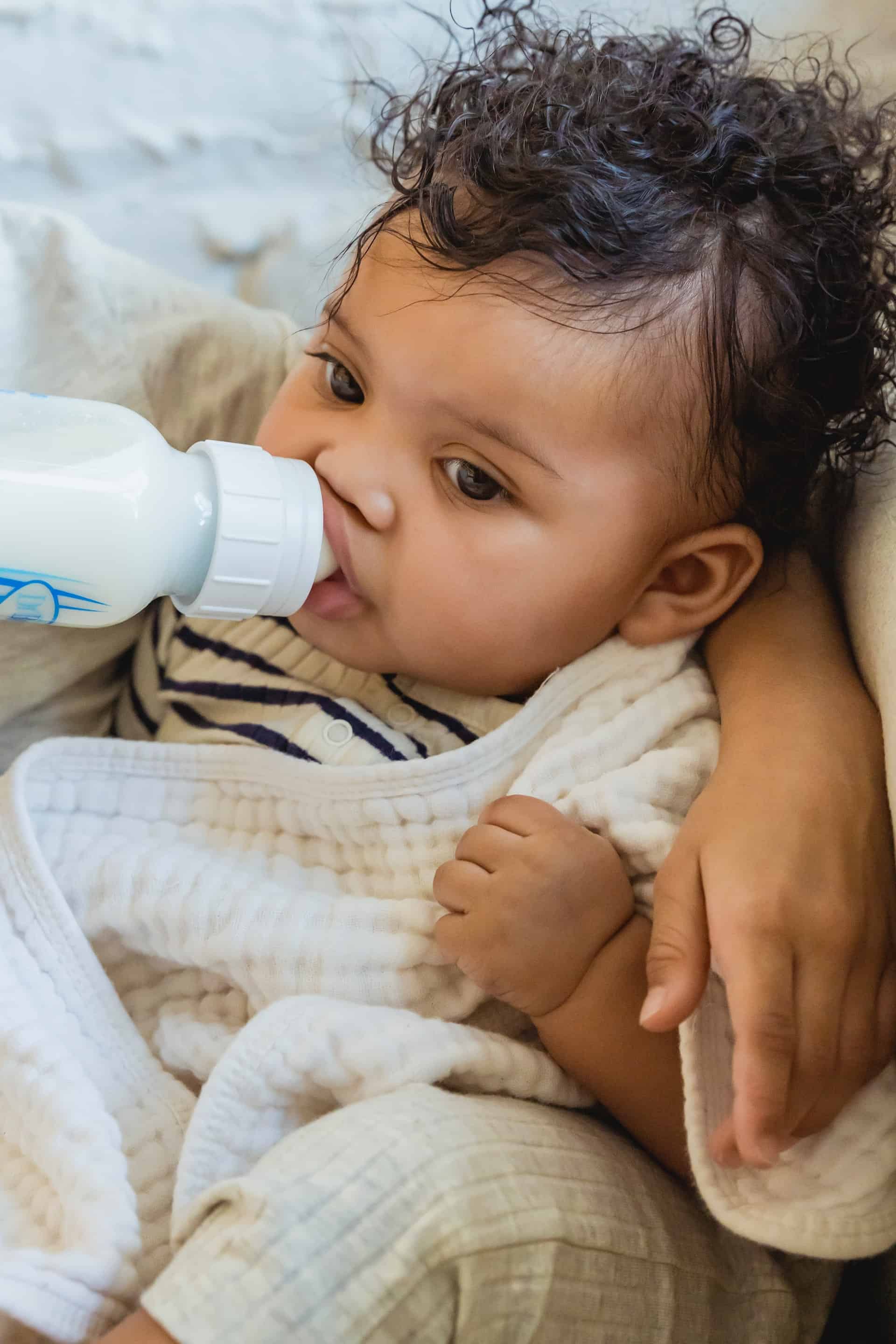 A young baby drinking from a bottle