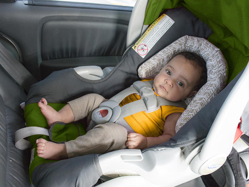 baby in a travel car seat