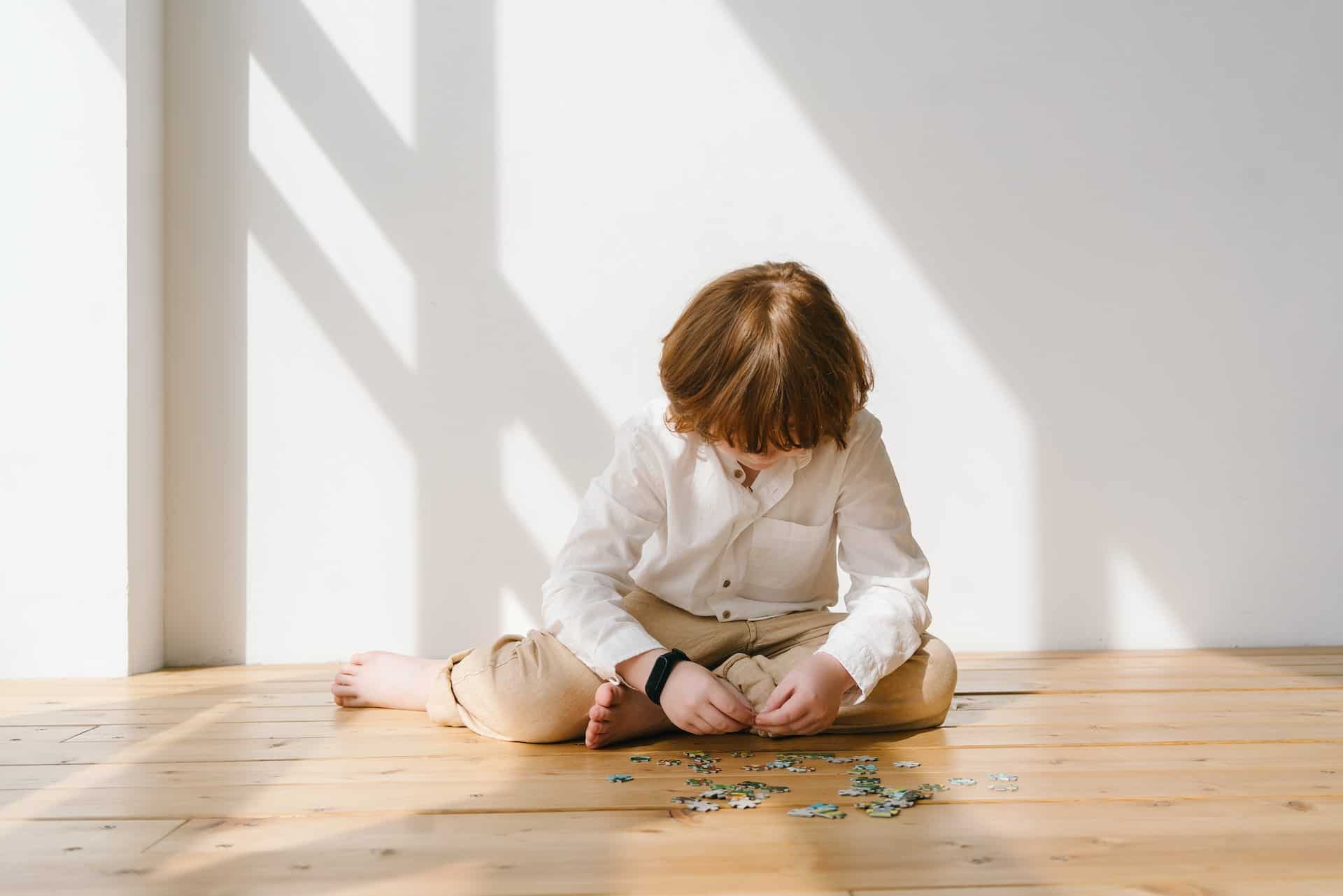 Child on ground with puzzle  