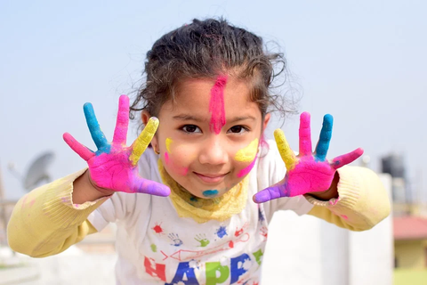 child with colorful hands