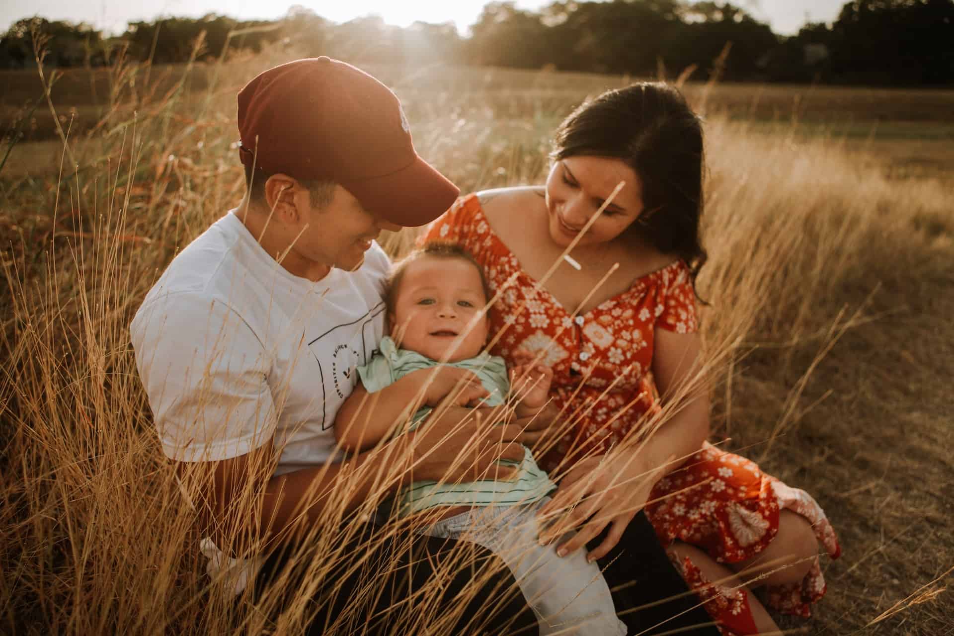 Couple with baby in field