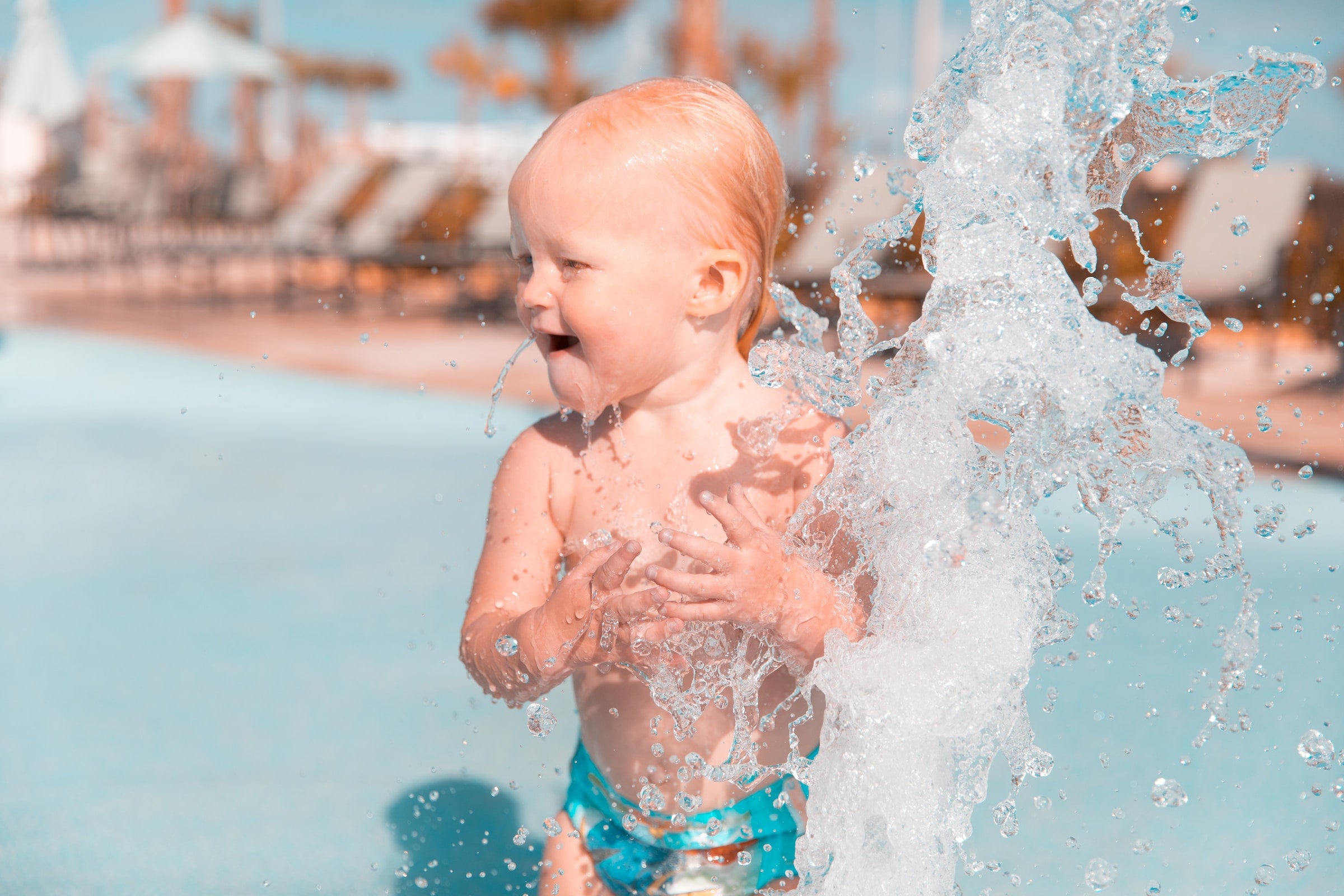 baby splashing at a pool