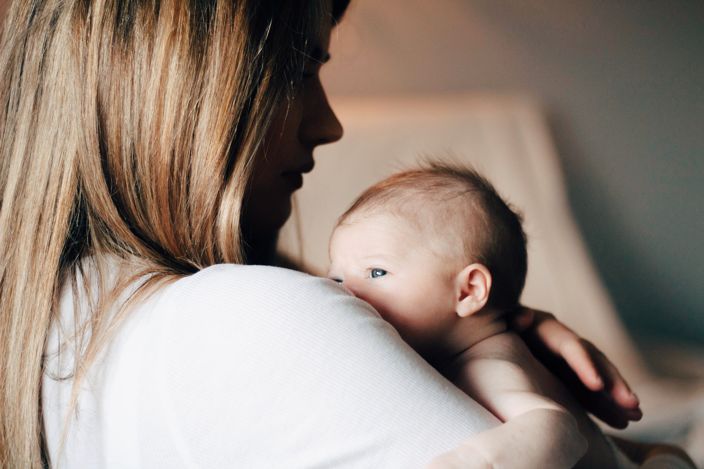 woman in her fourth trimester holding her baby