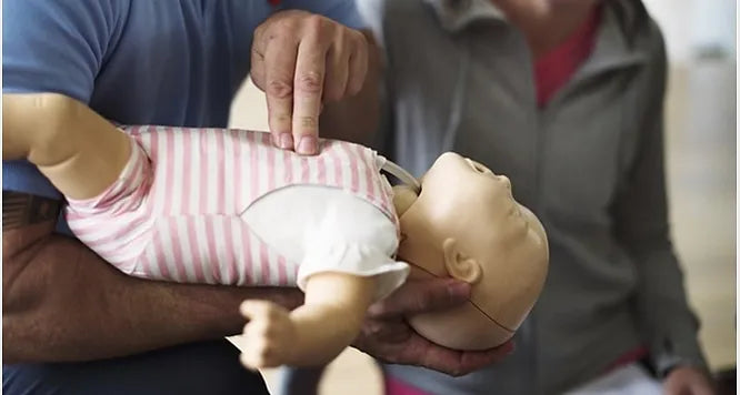 Man doing cpr on doll