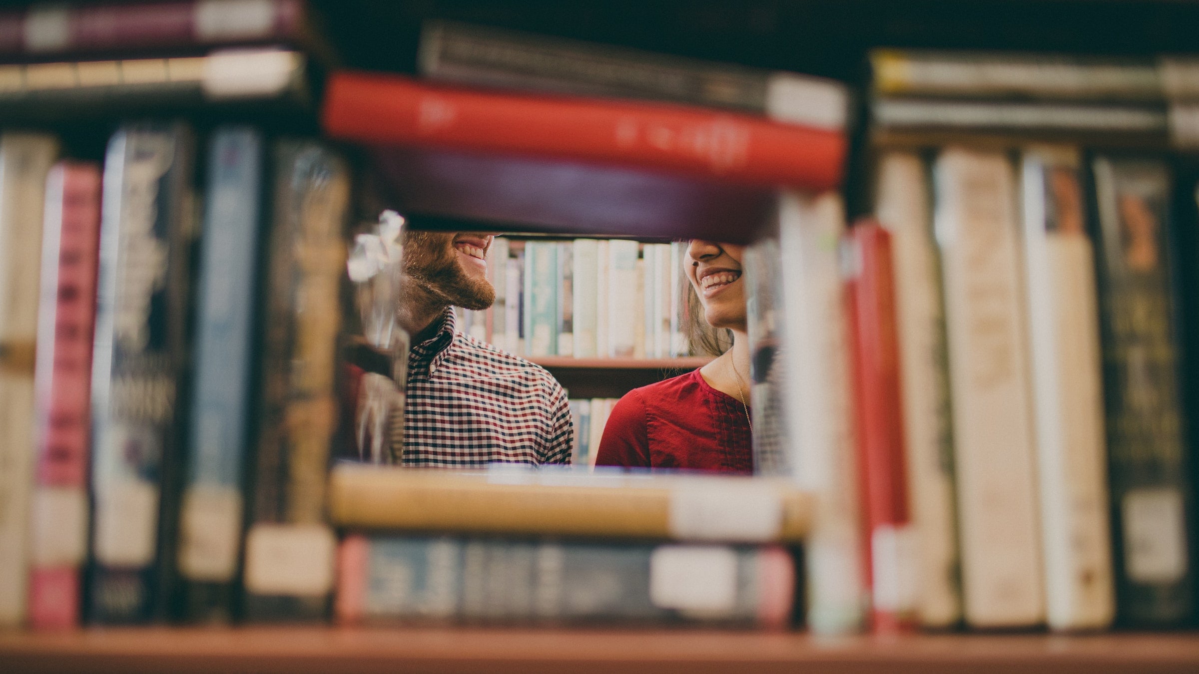 couple in a library surrounded by books