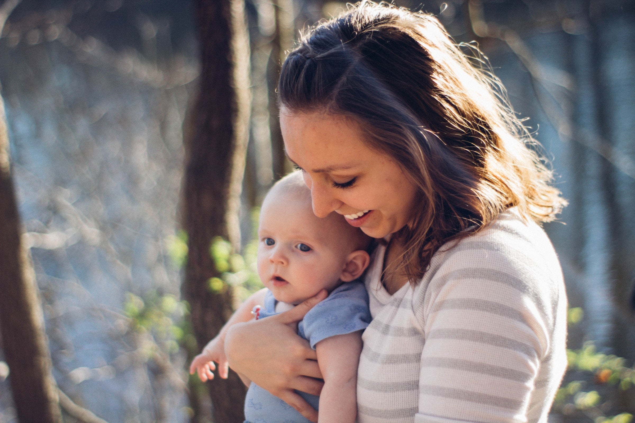 mother holding her baby outside