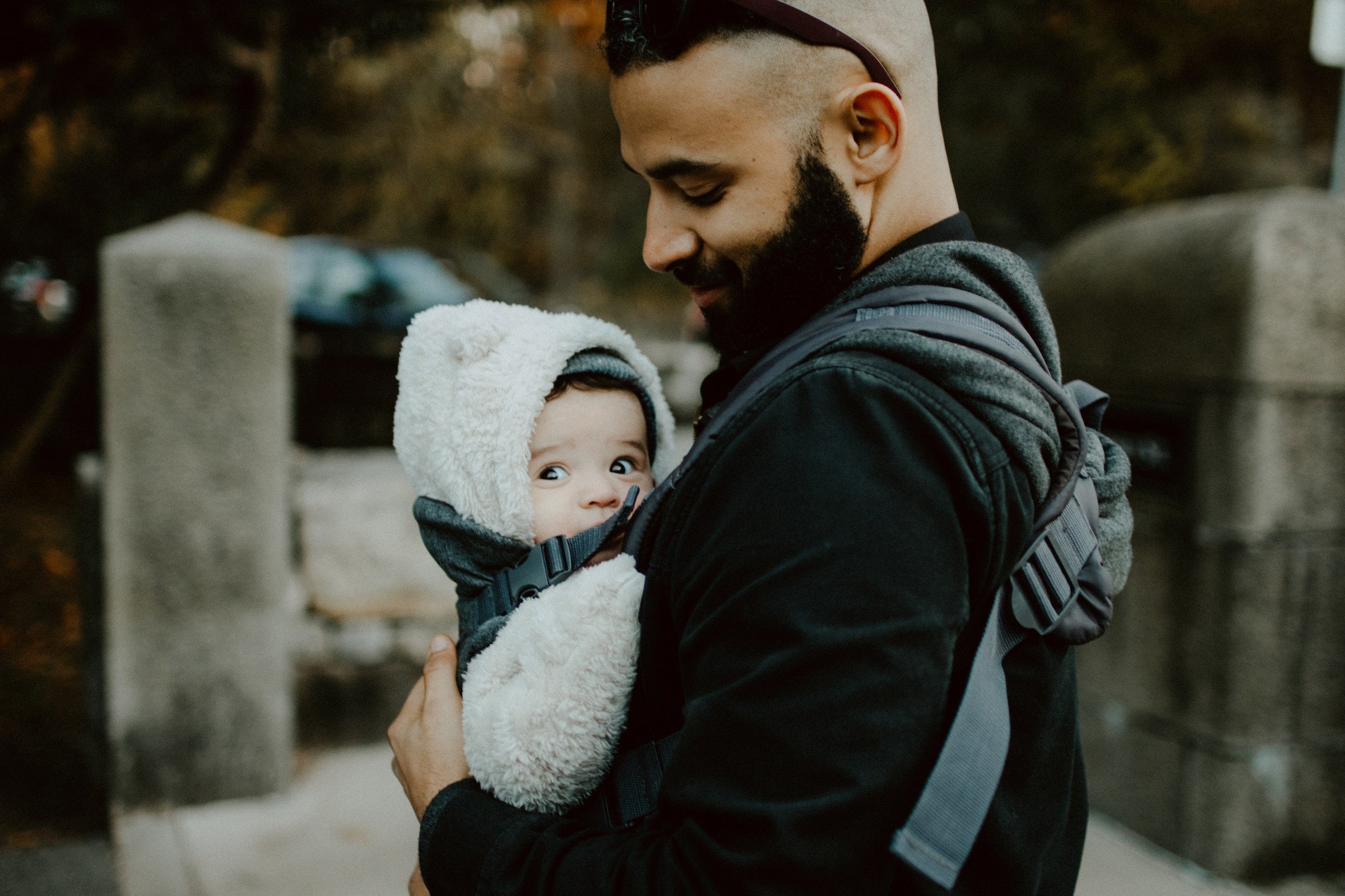 dad holding a baby in a baby carrier