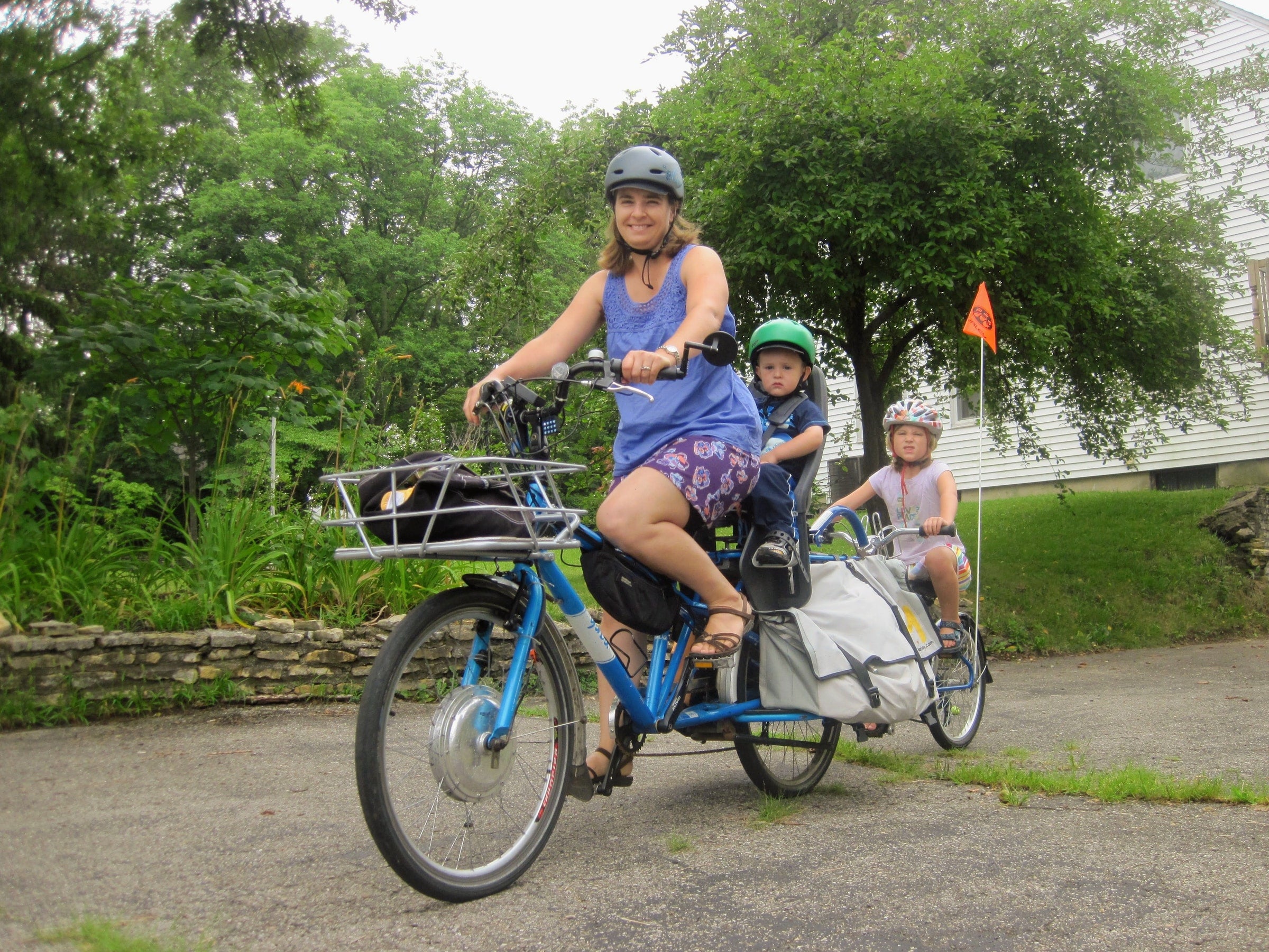 mother riding a bike with her kids