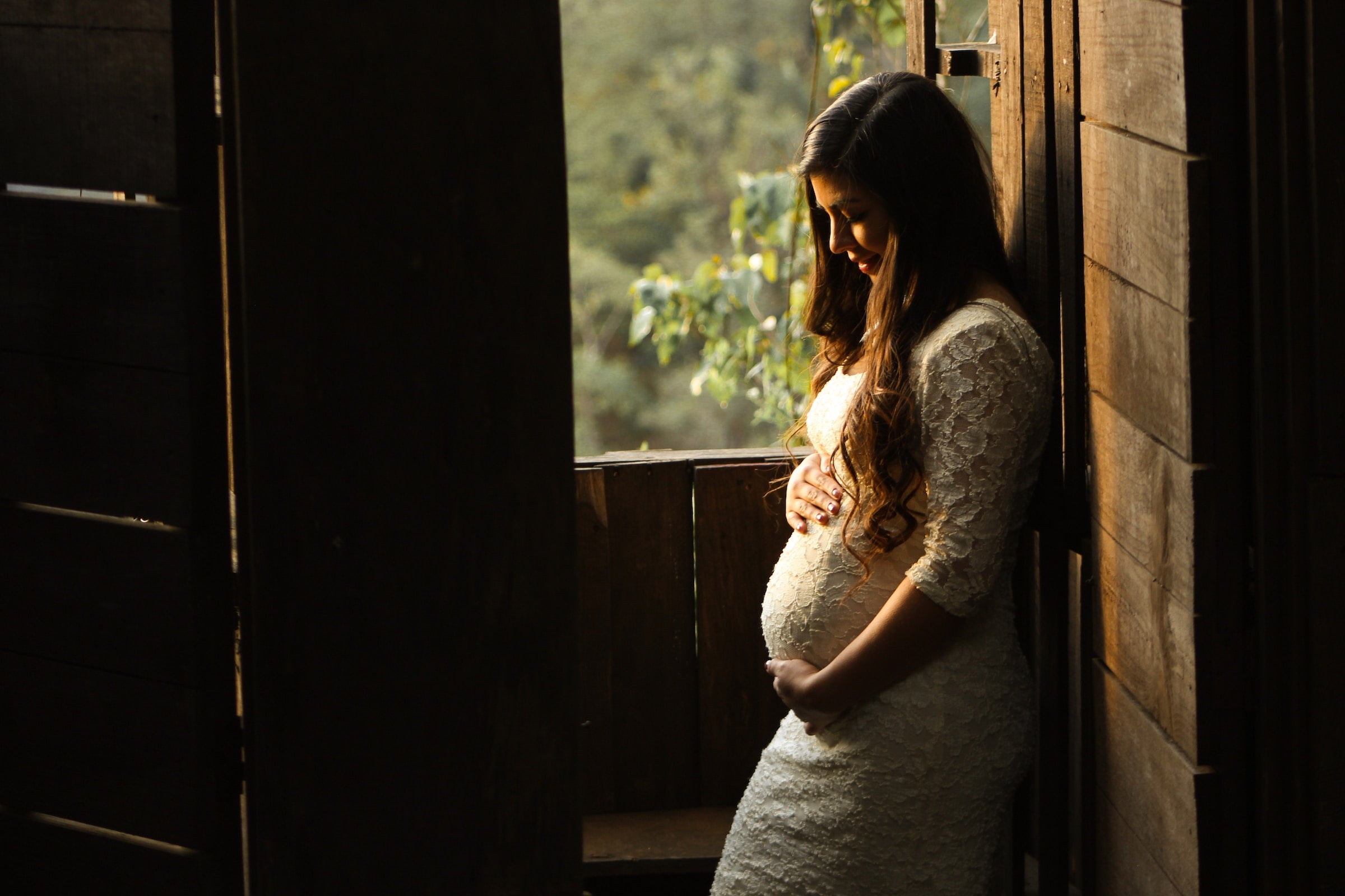 Pregnant woman outside in barn