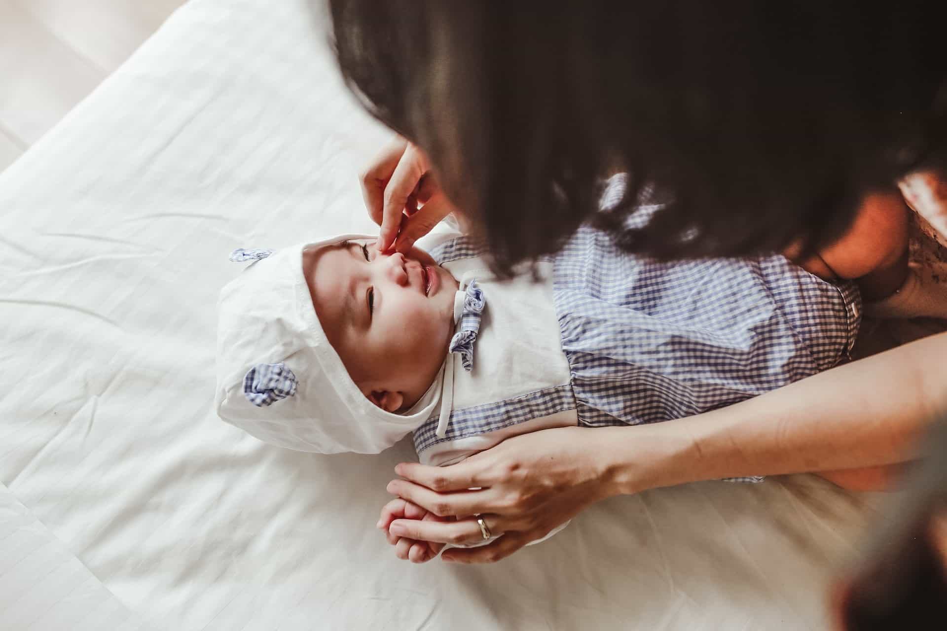 Mother Stroking Baby’s Face