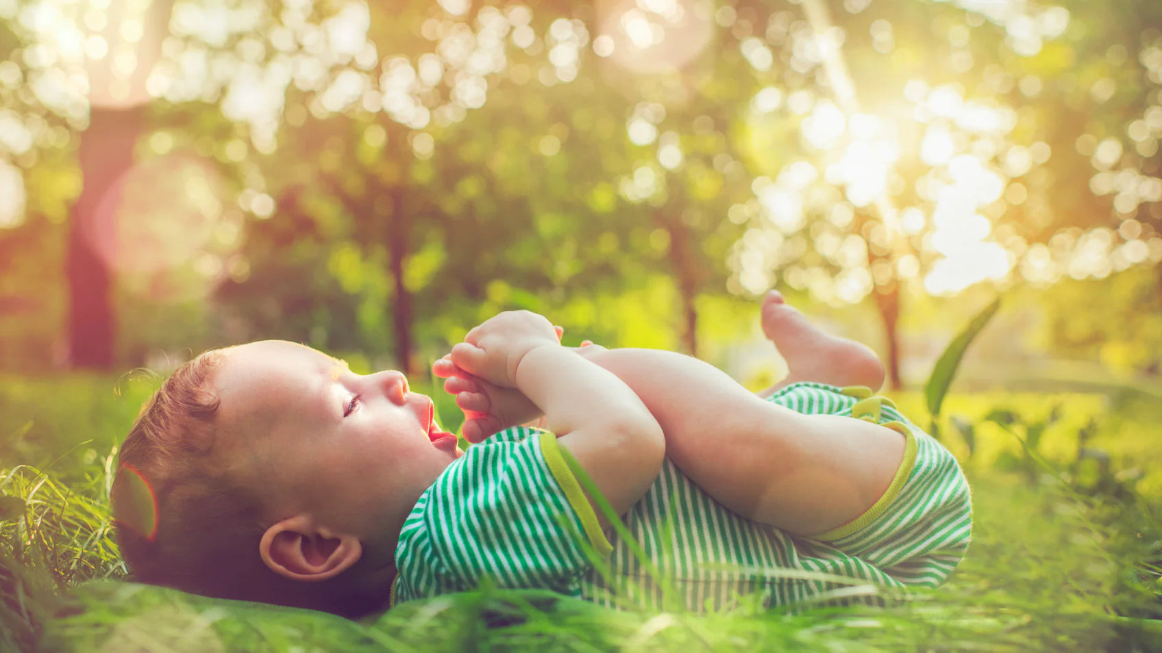 Baby laying on grass